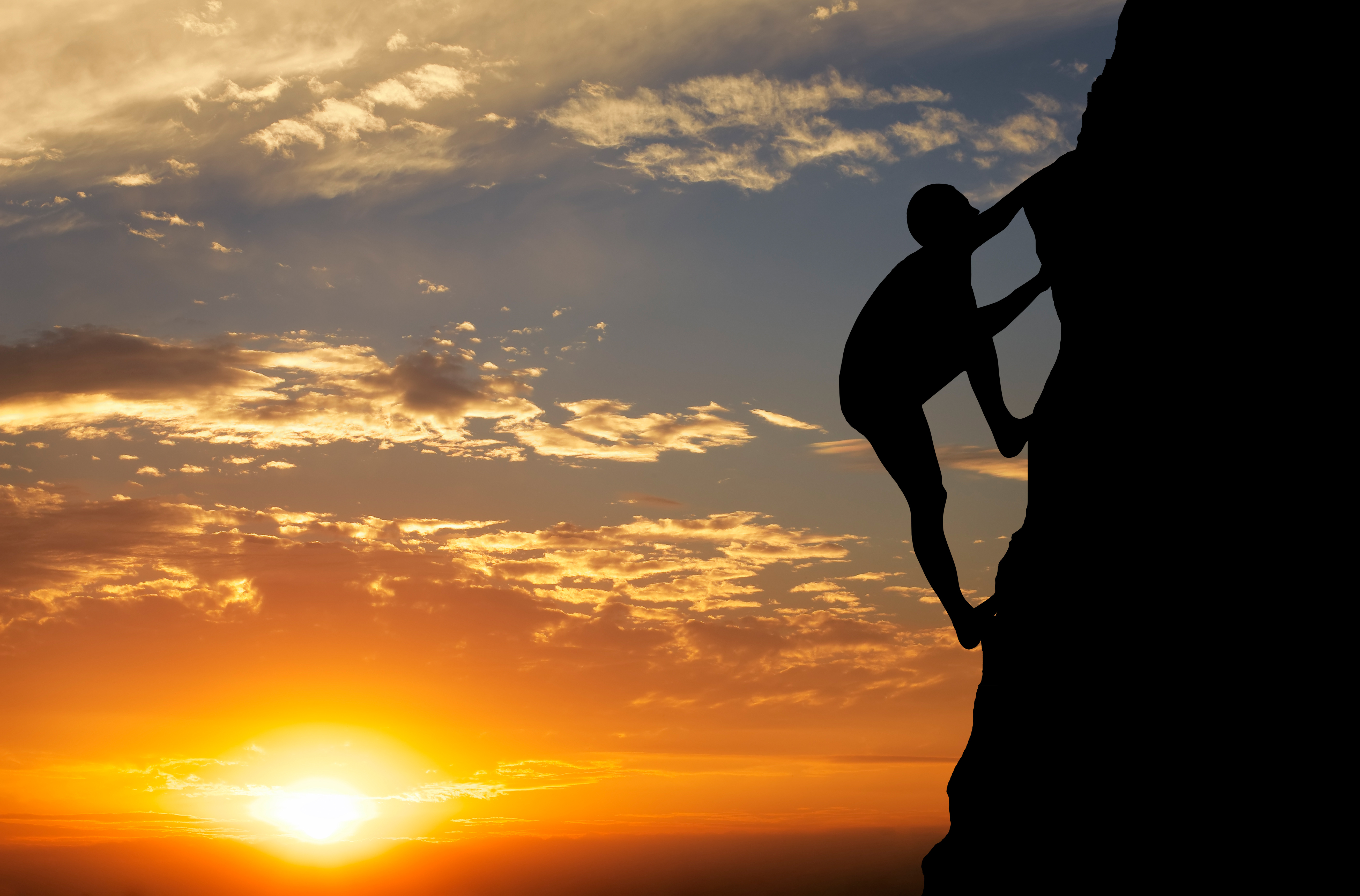 Rock climber at sunset background. Sport and active life