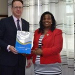 Prof. Olive Mugenda, the Vice-Chancellor giving a University pack to Paul Morton, General Manager , Hospital & Healthcare Solutions, GE Health during a visit in the University